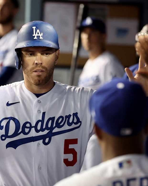 Sep 30, 2022; Los Angeles, California, USA; Los Angeles Dodgers first baseman Freddie Freeman (5) is greeted in the dugout after scoring a run during the fourth inning against the Colorado Rockies at Dodger Stadium. Mandatory Credit: Kiyoshi Mio-USA TODAY Sports